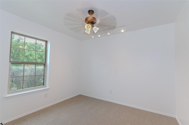 105 Fossil Way, Alvarado, TX 76009 - spare room with rail lighting, light carpet, and baseboards
