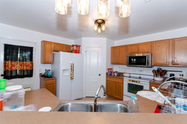 105 Fossil Way, Alvarado, TX 76009 - kitchen with white appliances, a sink, brown cabinets, and light countertops