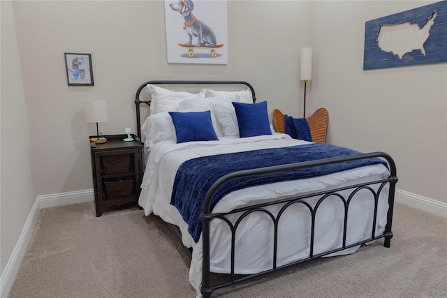 bedroom with carpet floors and baseboards