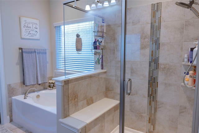 bathroom featuring a stall shower and a bath