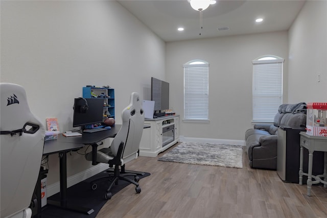 office space with baseboards, recessed lighting, light wood-style flooring, and ceiling fan