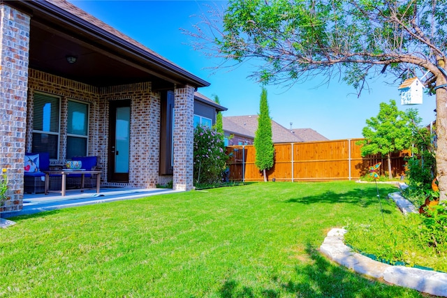 view of yard with a patio, outdoor lounge area, and a fenced backyard