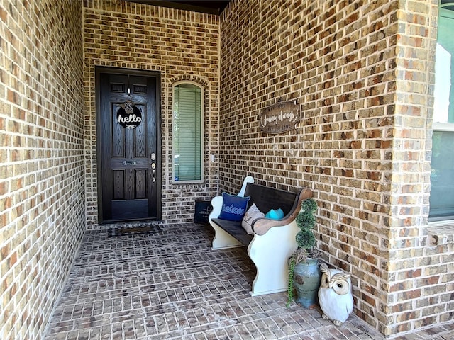 property entrance with brick siding