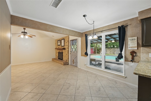 unfurnished dining area with visible vents, ornamental molding, and a fireplace