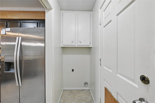 laundry room with hookup for an electric dryer, laundry area, a textured ceiling, light tile patterned floors, and baseboards
