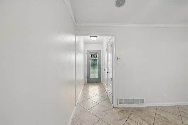 hall with crown molding, baseboards, light tile patterned floors, and visible vents