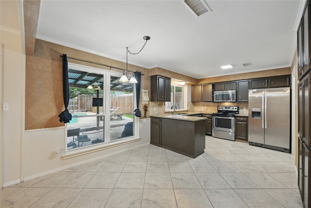 kitchen featuring crown molding, a peninsula, and appliances with stainless steel finishes