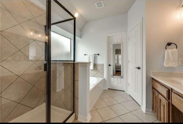full bathroom featuring tile patterned floors, vaulted ceiling, visible vents, a bath, and a stall shower