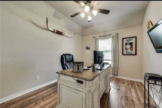 office space featuring baseboards, a ceiling fan, and wood finished floors