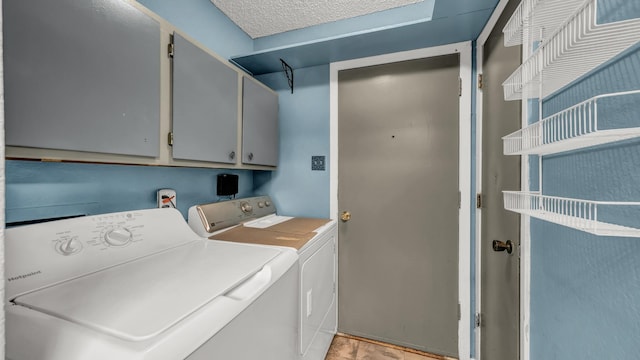 laundry room with cabinet space and washer and clothes dryer