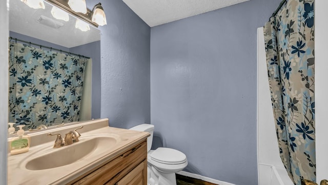 bathroom with a textured wall, vanity, toilet, a textured ceiling, and curtained shower