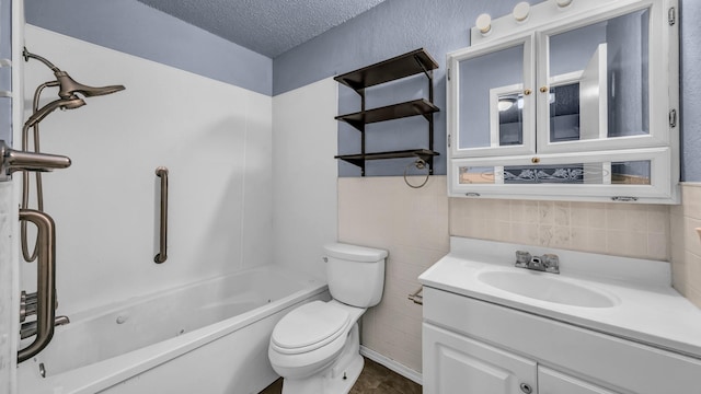 full bath with washtub / shower combination, vanity, toilet, a textured ceiling, and tile walls