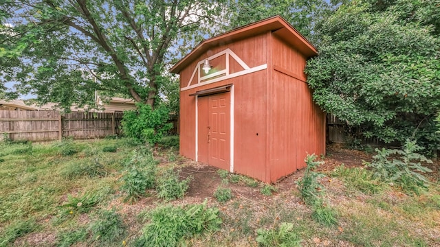 view of shed featuring fence