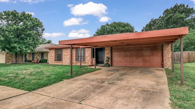 view of front of home with brick siding, an attached garage, fence, and a front yard