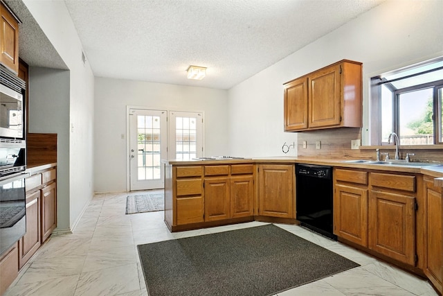 5834 Westhaven Dr Unit B, Fort Worth, TX 76132 - kitchen with a peninsula, a sink, black dishwasher, brown cabinetry, and marble finish floor