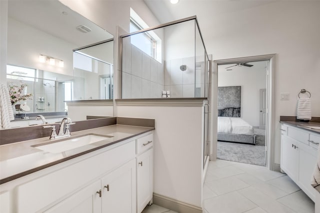ensuite bathroom featuring vanity, ensuite bathroom, a stall shower, and tile patterned flooring