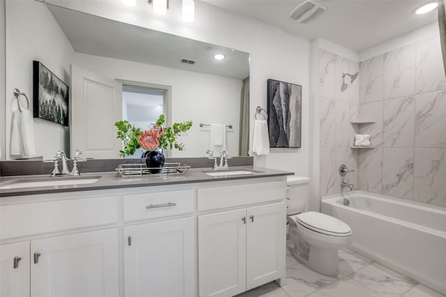 bathroom with double vanity, a sink, marble finish floor, and toilet