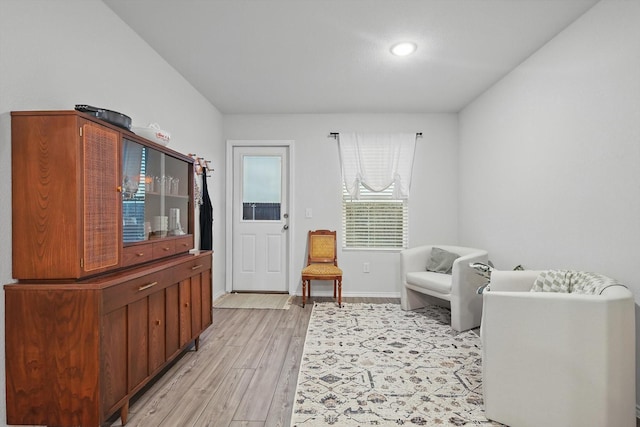 living area with recessed lighting, baseboards, and light wood-type flooring