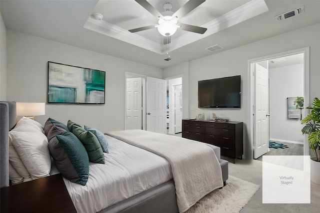 bedroom with crown molding, ceiling fan, visible vents, and a raised ceiling