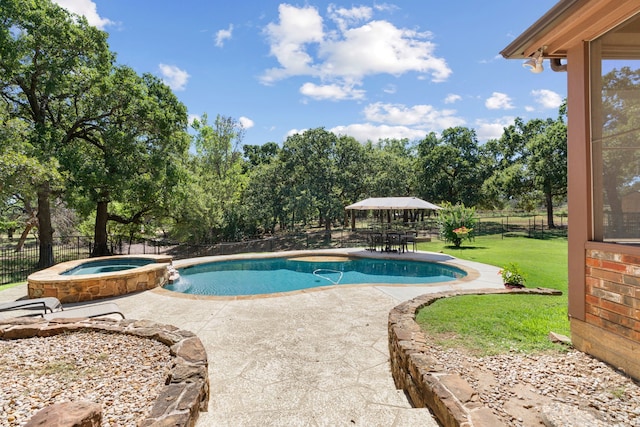 view of pool featuring a lawn, a fenced backyard, a patio area, and a pool with connected hot tub