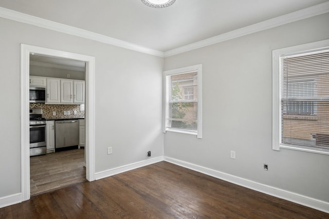 2653 Almeda Dr, Dallas, TX 75216 - unfurnished dining area featuring ornamental molding, dark wood-type flooring, and baseboards