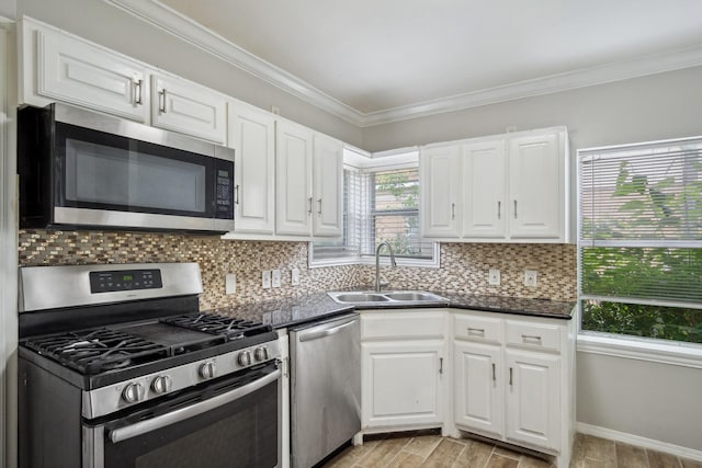 2653 Almeda Dr, Dallas, TX 75216 - kitchen featuring stainless steel appliances, a sink, dark countertops, decorative backsplash, and ornamental molding