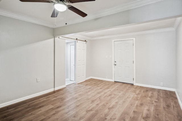2653 Almeda Dr, Dallas, TX 75216 - unfurnished room with ceiling fan, wood finished floors, baseboards, ornamental molding, and a barn door