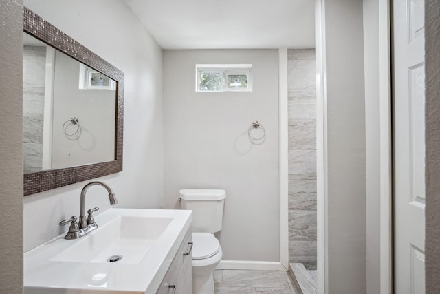 2653 Almeda Dr, Dallas, TX 75216 - full bath with marble finish flooring, toilet, vanity, tiled shower, and baseboards