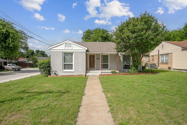 2653 Almeda Dr, Dallas, TX 75216 - ranch-style house with covered porch, a front lawn, and brick siding