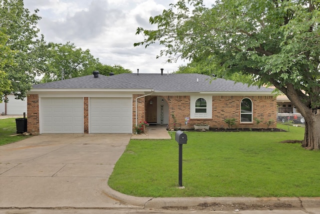 ranch-style house with brick siding, a garage, a front lawn, and concrete driveway