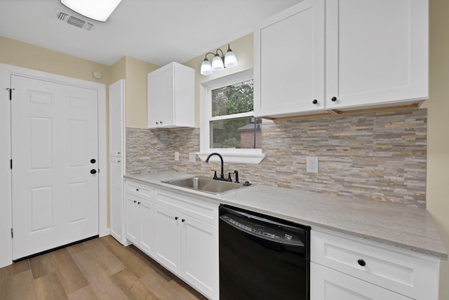 kitchen with visible vents, light wood-type flooring, dishwasher, a sink, and white cabinetry