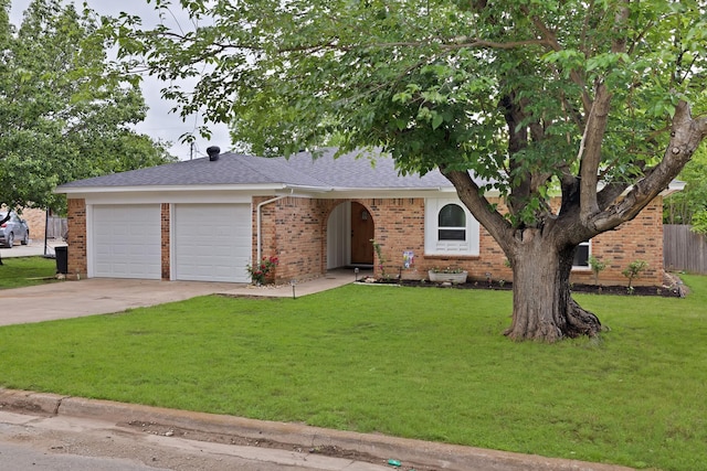 view of front of property featuring roof with shingles, brick siding, a garage, a front yard, and concrete driveway