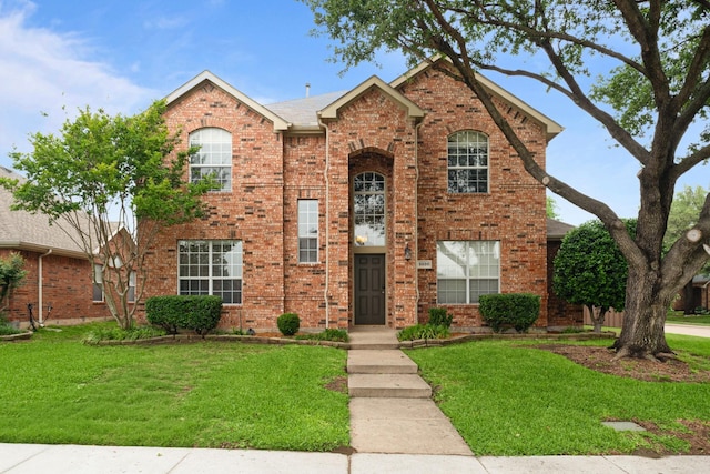 traditional-style house with brick siding and a front yard