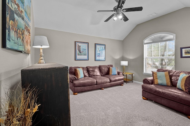 living area featuring lofted ceiling, visible vents, ceiling fan, and carpet