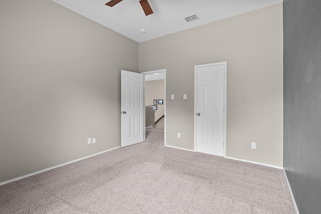 unfurnished bedroom featuring baseboards, a ceiling fan, visible vents, and carpet floors