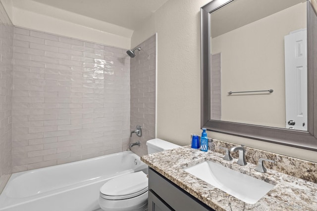 full bath with toilet, vanity, bathtub / shower combination, and a textured wall