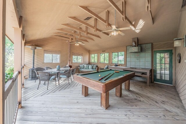 playroom featuring billiards, ceiling fan, a wall unit AC, wood walls, and vaulted ceiling with beams