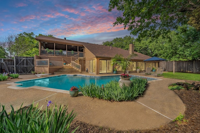 view of swimming pool with a fenced in pool, a fenced backyard, a patio area, and stairway