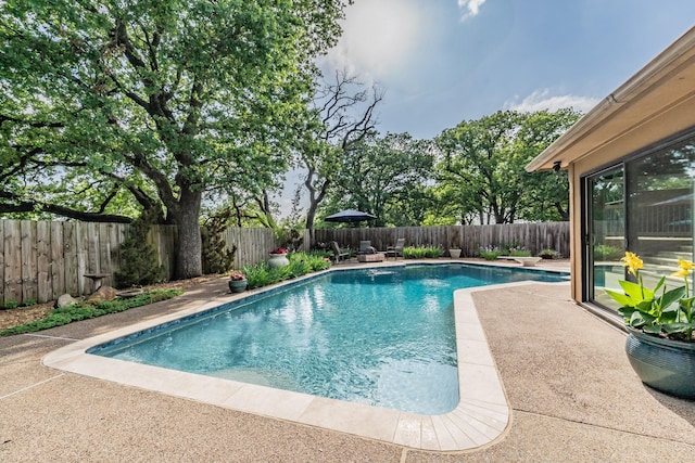 view of pool featuring a patio, a fenced in pool, and a fenced backyard