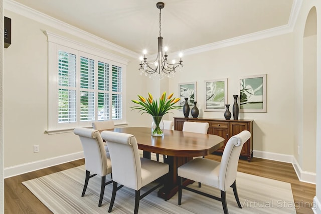 1713 Broadmoor Dr, Keller, TX 76262 - dining room with a chandelier, ornamental molding, light wood-style flooring, and arched walkways