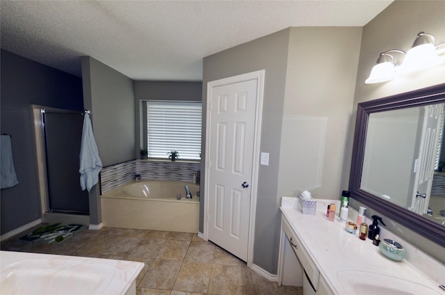 full bathroom with vanity, baseboards, a textured ceiling, a bath, and a stall shower
