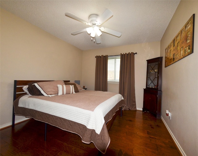 bedroom with baseboards, a ceiling fan, and wood finished floors