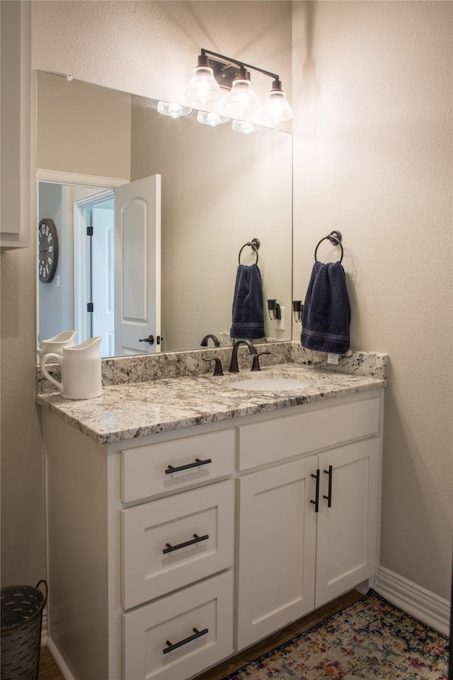 bathroom with vanity and baseboards