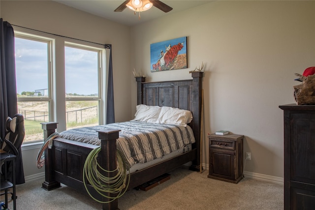 bedroom with light colored carpet, baseboards, and multiple windows
