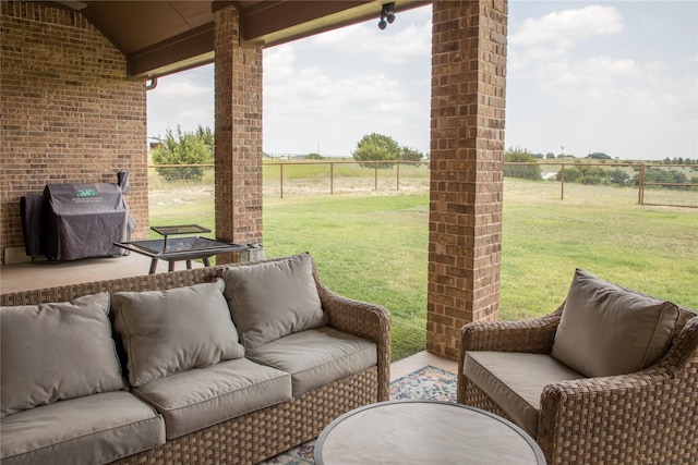 view of patio featuring area for grilling, fence, a rural view, and outdoor lounge area