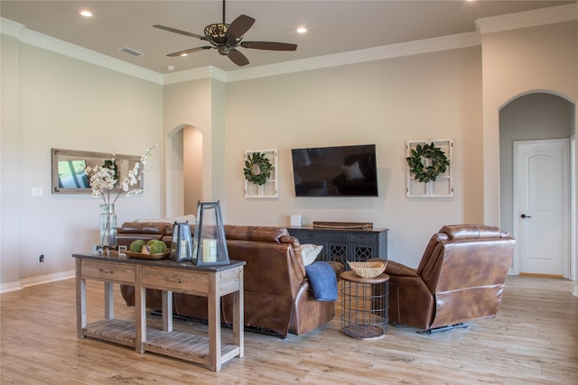 living area with arched walkways and light wood finished floors