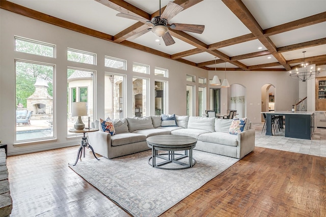 1342 Steeple Chase Ln, Aledo, TX 76008 - living area with arched walkways, beam ceiling, ceiling fan with notable chandelier, coffered ceiling, and light wood-style flooring