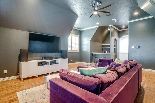 1342 Steeple Chase Ln, Aledo, TX 76008 - home theater room featuring a ceiling fan, visible vents, arched walkways, baseboards, and light wood finished floors