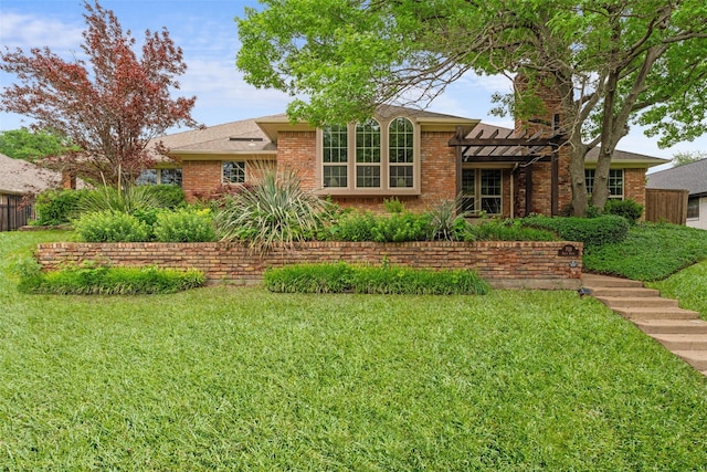 single story home featuring brick siding, a pergola, and a front yard