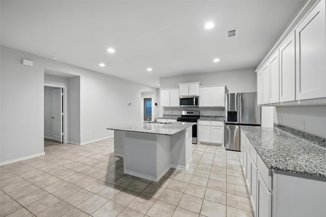 624 Whitecomb Ln, Justin, TX 76247 - kitchen with light tile patterned floors, stainless steel appliances, recessed lighting, and white cabinetry